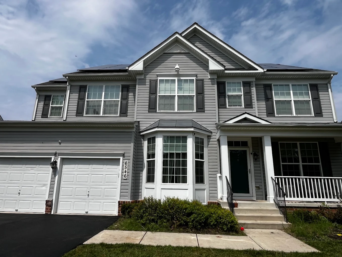 Freshly painted gray siding and white trim on a home repainted by Pikesville Painters in Maryland